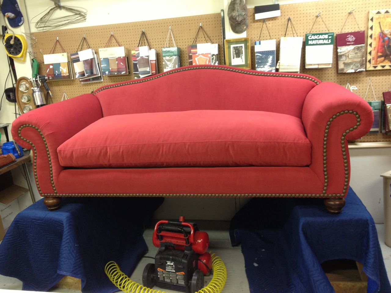 This red sofa featured decorative tacks. Although more meticulous work, the end result makes a statement.